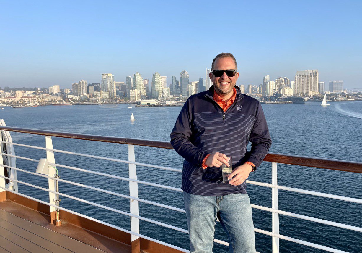 A man standing on the deck of a boat.