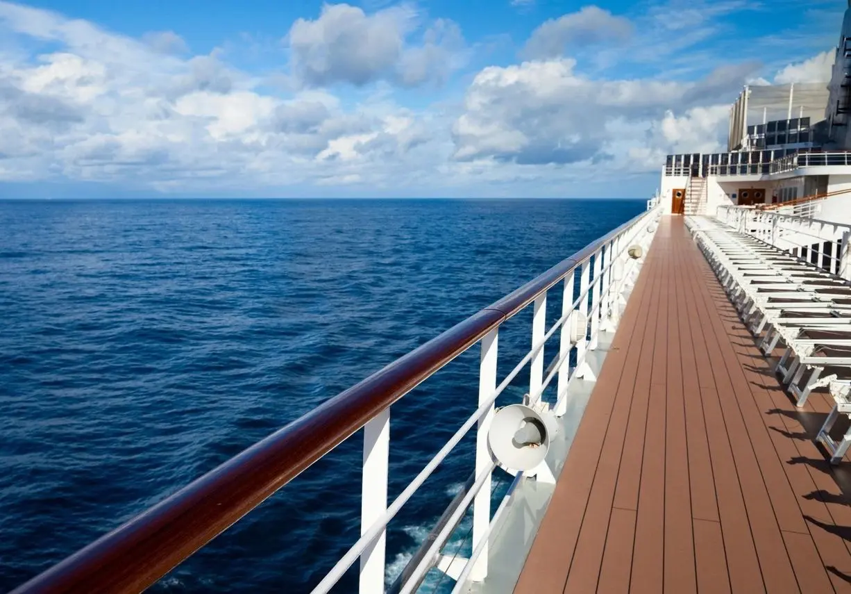 A deck of a ship with the ocean in the background.
